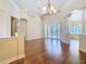 Elegant living room with hardwood floors, decorative columns, and a view of the pool at 2664 Keystone Springs Rd, Tarpon Springs, FL 34688