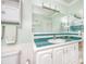 Bathroom with wainscotting, a white vanity, ample counter space, and decorative starfish accents at 6025 Shore S Blvd # 311, Gulfport, FL 33707