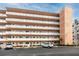 Charming condo building featuring multiple balconies, lush landscaping, and convenient parking spaces at 6025 Shore S Blvd # 311, Gulfport, FL 33707