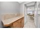 Hallway featuring tile flooring, and access to the dining area, enhancing the home's flow at 6025 Shore S Blvd # 311, Gulfport, FL 33707