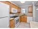 Bright kitchen equipped with modern appliances, including a gas range and built-in microwave at 6025 Shore S Blvd # 311, Gulfport, FL 33707