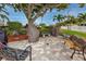 Secluded outdoor area with seating, providing a tranquil space amidst lush greenery and mature trees at 6025 Shore S Blvd # 311, Gulfport, FL 33707