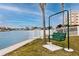 Outdoor green swing set along a waterfront with city views and white fencing at 6025 Shore S Blvd # 311, Gulfport, FL 33707