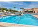 Beautiful pool area with ample seating, mature landscaping, and a clubhouse for community enjoyment at 6025 Shore S Blvd # 311, Gulfport, FL 33707