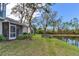 Landscaped backyard with a lake view, a patio and a green lawn at 6303 Green Oak Cir, Bradenton, FL 34203
