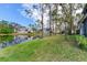 Scenic backyard featuring a tranquil pond and verdant grass, ideal for outdoor activities and peaceful relaxation at 6303 Green Oak Cir, Bradenton, FL 34203