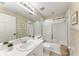 Bright bathroom features a tub-shower combo and large mirror at 6303 Green Oak Cir, Bradenton, FL 34203