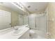 Well-lit bathroom featuring a sink and vanity, toilet, and shower with glass doors at 6303 Green Oak Cir, Bradenton, FL 34203