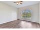 Empty bedroom with wood-look floors and natural light from the large window at 6303 Green Oak Cir, Bradenton, FL 34203