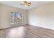Spacious bedroom with wood-look flooring and natural light from a large window at 6303 Green Oak Cir, Bradenton, FL 34203
