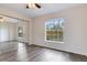 Well-lit bedroom with wood flooring, large window overlooking the pond, and ample closet space at 6303 Green Oak Cir, Bradenton, FL 34203