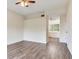 Open bedroom with wood-look floors, ceiling fan and direct access to bathroom at 6303 Green Oak Cir, Bradenton, FL 34203