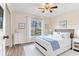 Beautifully decorated bedroom features a ceiling fan, a large window with curtains, and an accent wall at 6303 Green Oak Cir, Bradenton, FL 34203