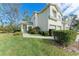 Charming two-story townhome featuring a well-manicured lawn, lush landscaping, and a two-car garage at 6303 Green Oak Cir, Bradenton, FL 34203