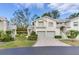 Well-maintained exterior of a two-story home with a two-car garage, manicured lawn, and lush landscaping at 6303 Green Oak Cir, Bradenton, FL 34203