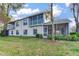Back of home with two stories, a screen patio and an outside balcony at 6303 Green Oak Cir, Bradenton, FL 34203
