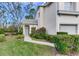 Charming home exterior featuring a well-manicured lawn, inviting walkway, and lush landscaping at 6303 Green Oak Cir, Bradenton, FL 34203