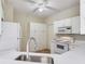 Bright kitchen featuring white cabinets, modern appliances, and a view of the sink and cooktop at 6303 Green Oak Cir, Bradenton, FL 34203