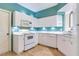 Well-lit kitchen with white cabinets and appliances, offering a clean and efficient space at 6303 Green Oak Cir, Bradenton, FL 34203