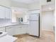 Bright kitchen features white cabinetry, subway tile backsplash, and stainless-steel appliances overlooking the living area at 6303 Green Oak Cir, Bradenton, FL 34203