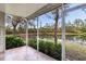 Enclosed lanai overlooking serene water view and lush greenery, perfect for relaxing and enjoying the outdoors at 6303 Green Oak Cir, Bradenton, FL 34203
