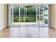 Spacious lanai area with tiled flooring, offering serene views of the lush backyard and waterfront at 6303 Green Oak Cir, Bradenton, FL 34203