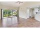 Expansive living area with tile floors, opening to a screened lanai and offering water views at 6303 Green Oak Cir, Bradenton, FL 34203
