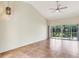 Living room features vaulted ceiling, tile flooring and sliding glass doors to screened lanai with tranquil views at 6303 Green Oak Cir, Bradenton, FL 34203