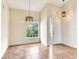 Bright, open living room with tile floors and modern lighting fixtures and front door at 6303 Green Oak Cir, Bradenton, FL 34203