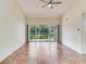 Spacious living room with neutral walls, tile flooring and sliding doors with a beautiful water view at 6303 Green Oak Cir, Bradenton, FL 34203