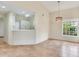 Spacious living area with tile flooring, open to the kitchen, and well-lit by natural light at 6303 Green Oak Cir, Bradenton, FL 34203