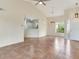 Bright, open living area featuring tile floors, high ceilings, and seamless kitchen access at 6303 Green Oak Cir, Bradenton, FL 34203