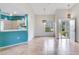 Open-concept living area featuring tile floors, a breakfast bar, and access to the screened-in porch at 6303 Green Oak Cir, Bradenton, FL 34203
