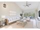Bright living room featuring high ceilings, neutral tones, and sliding glass doors leading to a patio at 6303 Green Oak Cir, Bradenton, FL 34203