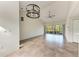 Open living room with vaulted ceiling, tile flooring and sliders that open to a screened lanai with water views at 6303 Green Oak Cir, Bradenton, FL 34203