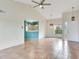 Bright living room featuring tile floors, high ceilings, and an open view to the modern kitchen at 6303 Green Oak Cir, Bradenton, FL 34203