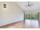 Open living room with tile floors, vaulted ceilings, and sliding doors that provide lots of natural light at 6303 Green Oak Cir, Bradenton, FL 34203