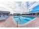 Community pool with sun loungers and umbrellas provides a relaxing outdoor space at 6303 Green Oak Cir, Bradenton, FL 34203