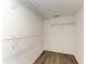 Simple walk-in closet with hanging racks at 6303 Green Oak Cir, Bradenton, FL 34203