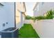 Green backyard with white fence and grass at 716 S Lois Ave, Tampa, FL 33609