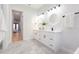 Bright bathroom features double vanity, modern lighting, and an open doorway at 716 S Lois Ave, Tampa, FL 33609