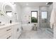 Modern bathroom features a glass shower, freestanding tub, and double vanity at 716 S Lois Ave, Tampa, FL 33609