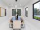 Bright dining room featuring dark framed windows, a modern light fixture, and seating for eight at 716 S Lois Ave, Tampa, FL 33609