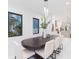 Bright dining room featuring dark framed windows, a modern light fixture, and seating for eight at 716 S Lois Ave, Tampa, FL 33609