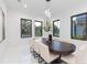 Bright dining room featuring dark framed windows, a modern light fixture, and seating for eight at 716 S Lois Ave, Tampa, FL 33609