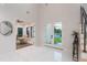 Welcoming foyer leads to a bright home office and double glass doors, showcasing the home's open floor plan at 716 S Lois Ave, Tampa, FL 33609