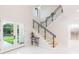 Bright foyer boasts high ceilings, a modern staircase with glass railings, and elegant double doors to the outside at 716 S Lois Ave, Tampa, FL 33609