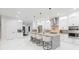 Stylish kitchen featuring a large island with barstool seating, stainless steel appliances, and sleek design at 716 S Lois Ave, Tampa, FL 33609