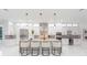 Modern kitchen with white cabinets, a large island with seating, and stainless steel appliances at 716 S Lois Ave, Tampa, FL 33609