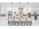 Bright kitchen featuring a center island with barstool seating, stainless steel appliances, and sleek fixtures at 716 S Lois Ave, Tampa, FL 33609